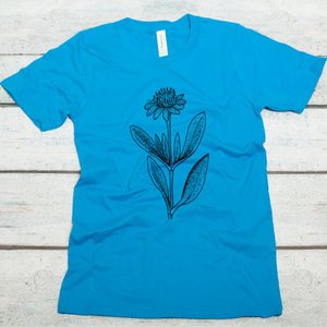 Sea daisy screen printed in black water-based ink on a malibu blue organic cotton unisex tshirt