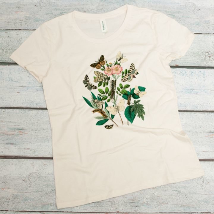 botanical print of butterflies, flowers, caterpillars on a natural women's organic cotton tee