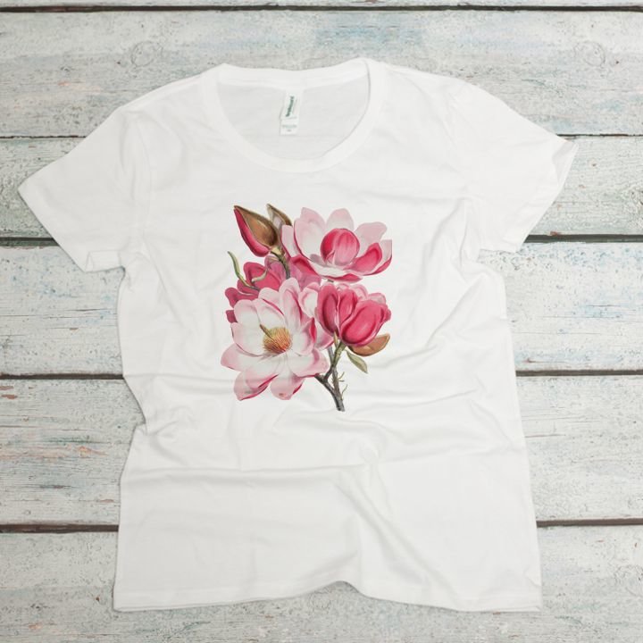 Pink magnolia flowers on a white women's organic cotton t-shirt